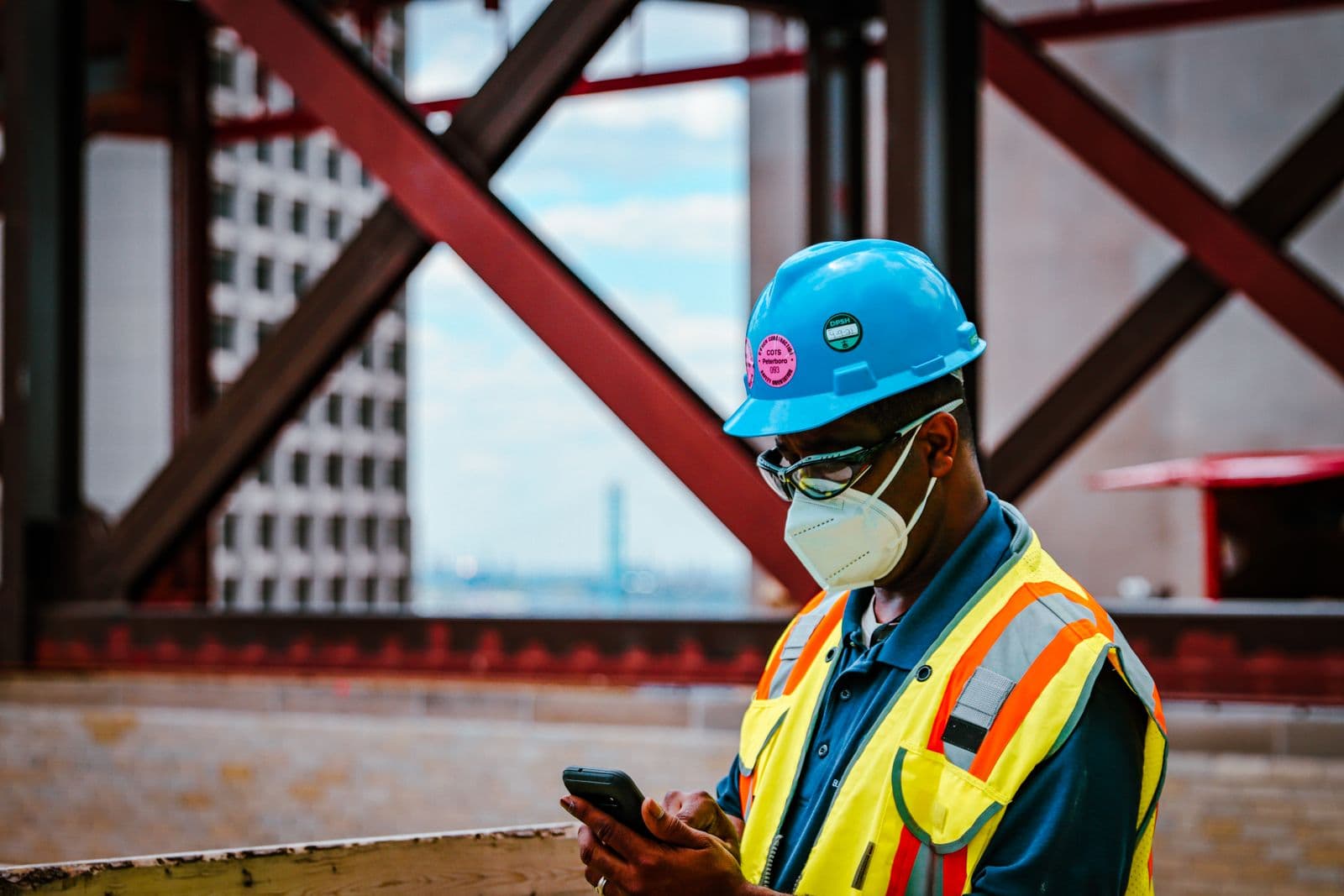 Tradesperson checking a phone on site