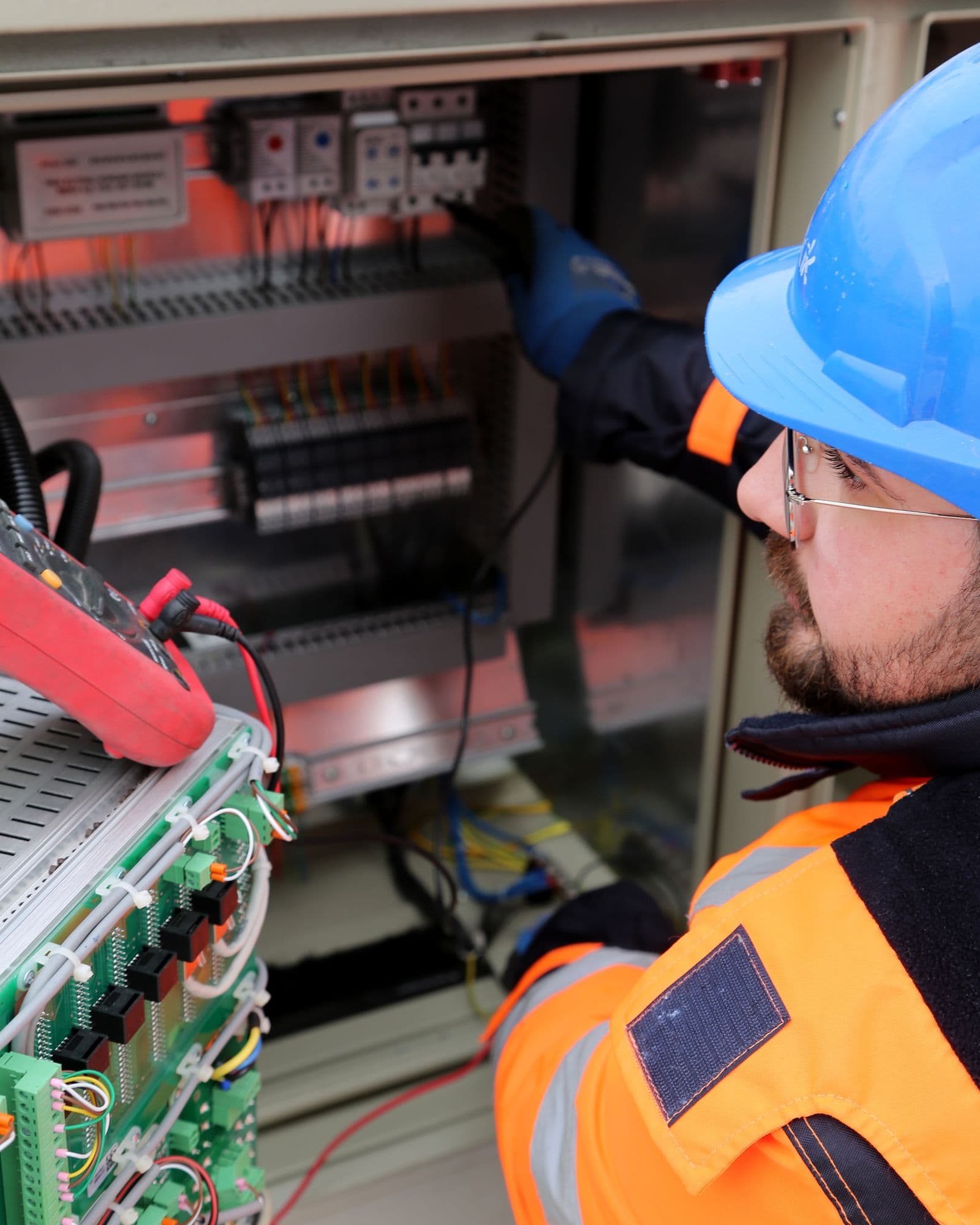 Electrician working with switchboard equipment